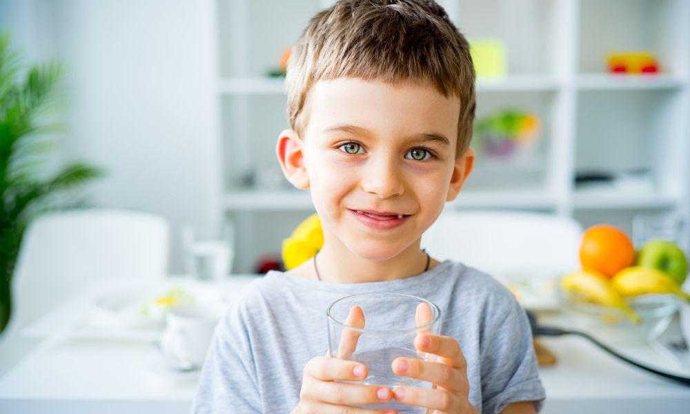 Boy drinking clean water in kitchen